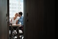 Two Co-Workers Sitting At Office Desk And Kissing Royalty Free Stock Photo