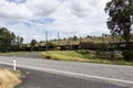 Two coal trains passing on electric railway lines.