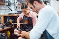 Two cobblers working together in the workshop Royalty Free Stock Photo