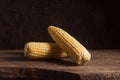 Two cobs sweet corn on wooden background