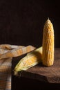 Two cobs sweet corn on wooden background