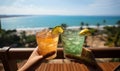 Two cocktail glasses in the hands on sea background. Summer vacation concept Tropical ocean view on summer Holiday Royalty Free Stock Photo