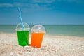 Two cocktails drink sand close-up against the background of the sea and sky, clouds a glass a tube for drinking liquid, soda