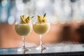 Two cocktails pina colada at barcounter in night club or restaurant Royalty Free Stock Photo