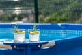 Two cocktails on a portable swimming pool