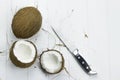 Two coconut pulp fresh tropical brown white organic coconut coconut flakes milk knife on wooden white background