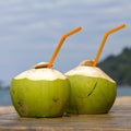 Two coconut water drink on the table in tropical beach cafe Royalty Free Stock Photo