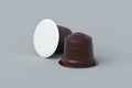 Two coffee capsules on gray background. Modern decaf pods for machine.