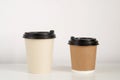 Two coffee cup mockup on the white background. Empty cups for americano and cappuccino on the table Royalty Free Stock Photo