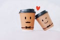 Two coffee cup with smiling face of man homosexual couples together with heart on white background.Concept of happy LGBT people in