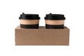 Two standart beige and brown coffee cups in cupholder for two mugs isolated on clean white background. Take away concept