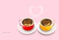 Two coffee cups, decorated with coffee beans in the form of heart, stand together with fragrant steam in the form of heart on pink