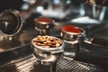 Two coffee holders one with fresh ground coffee another with roasted beans standing on coffee machine close up