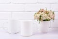 Two coffee mug mockup with pink beige wild flowers