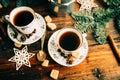 Two cups of espresso with pieces of cane sugar and Italian coffee maker on wooden table. Royalty Free Stock Photo