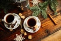 Two cups of espresso with pieces of cane sugar and Italian coffee maker on wooden table. Royalty Free Stock Photo