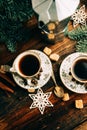 Two cups of espresso with pieces of cane sugar and Italian coffee maker on wooden table. Royalty Free Stock Photo