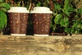 Two coffees to go on the wooden balcony. Lifestyle concept