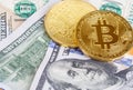 Two coins of bitcoin on banknotes of one hundred dollars. Exchange bitcoin cash for a dollar Royalty Free Stock Photo