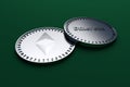 Two coins of digital crypto currency Ethereum lying on green cloth, 3D rendering.