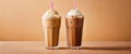 Two cold latte coffee drinks with ice cream or cream with a straw in clear glass faceted glasses on a table on a plain Royalty Free Stock Photo