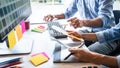 Two colleague creative graphic designer working on color selection and color swatches, drawing on graphics tablet at workplace