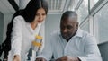 Two colleagues business partners office co-workers analyze paperwork check information. Arabian woman check Royalty Free Stock Photo