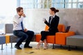 Two colleagues chatting on coffee break. Royalty Free Stock Photo