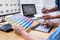 Two colleagues creative graphic designer working on color selection and drawing on graphics tablet at workplace, Color swatch Royalty Free Stock Photo