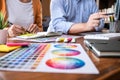 Two colleagues creative graphic designer working on color selection and drawing on graphics tablet at workplace Royalty Free Stock Photo