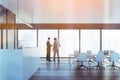 Two colleagues discussing clients business case before the meeting in modern panoramic office in downtown. reception area and Royalty Free Stock Photo