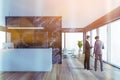 Two colleagues discussing clients business case before the meeting in modern panoramic office in downtown. reception area and Royalty Free Stock Photo