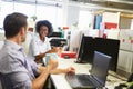 Two colleagues having a coffee break at work