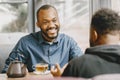 Two colleagues having a conversation with a cup of tea during the break Royalty Free Stock Photo