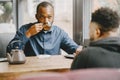 Two colleagues having a conversation with a cup of tea during the break Royalty Free Stock Photo