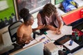 Two colleagues, male and female, caucasian and afro-american, working together on statistic data in office. top view, from above Royalty Free Stock Photo