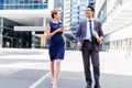 Two colleagues walking together in a city