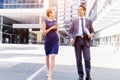 Two colleagues walking together in a city