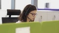 Two colleagues wearing headsets working in a call center