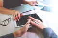 two colleagues website designer discussing data and digital tablet and computer laptop and smart phone on marble desk as Royalty Free Stock Photo