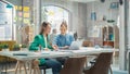 Two Colleagues Working On Laptop in Office. Female Help Desk Coordinator Collaborates with Caucasian Royalty Free Stock Photo