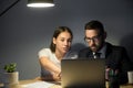 Two colleagues working on a problem in late evening meeting. Royalty Free Stock Photo