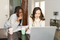 Two college girls studying together at home with laptops while drinking coffee Royalty Free Stock Photo