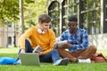 Two College Students Sitting on Grass Royalty Free Stock Photo