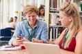 Two College Students Studying In Library Together Royalty Free Stock Photo