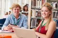 Two College Students Studying In Library Together Royalty Free Stock Photo