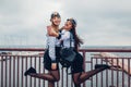 Two college women students of Marine academy taking selfie by sea wearing uniform. Happy friends having fun Royalty Free Stock Photo