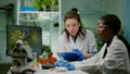 Two collegues checking sample of vegan meat writing biotechnology expertise