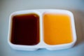 Two color tone of chinese sour and sweet sauce in white cup for dimsum.