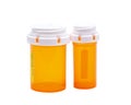 Two Colored Capsule, Pill Containers, Bottles Amber Color, Child Resistant Caps isolated on white Royalty Free Stock Photo